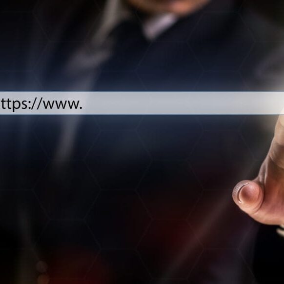 Businessman on Dark Background Touching Search or Favorite Button on Internet Browser over Virtual Screen